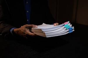 hands holding documents